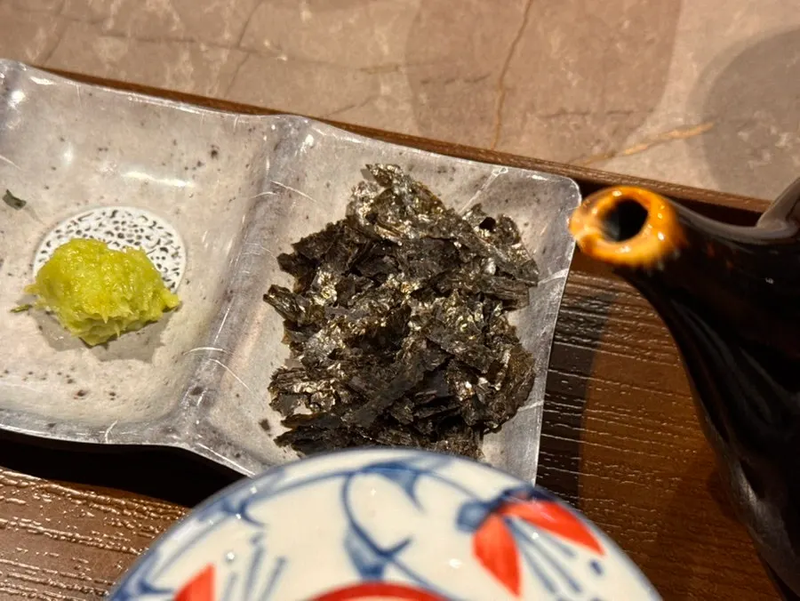 A piece of eel topped with wasabi