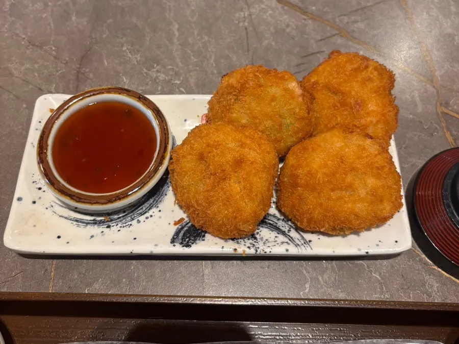 Vegetable croquette served with chili sauce