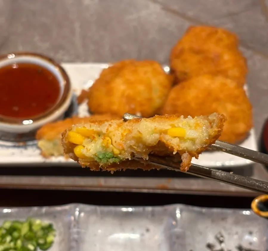 Vegetable croquette cut in half showing the filling