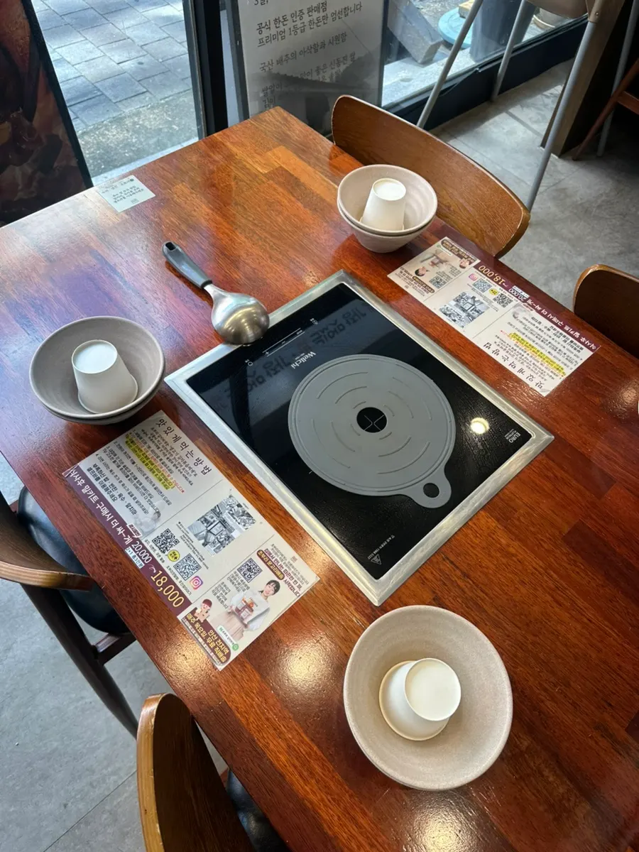 Menu board with topping prices at Choburi Kimchi Jjigae
