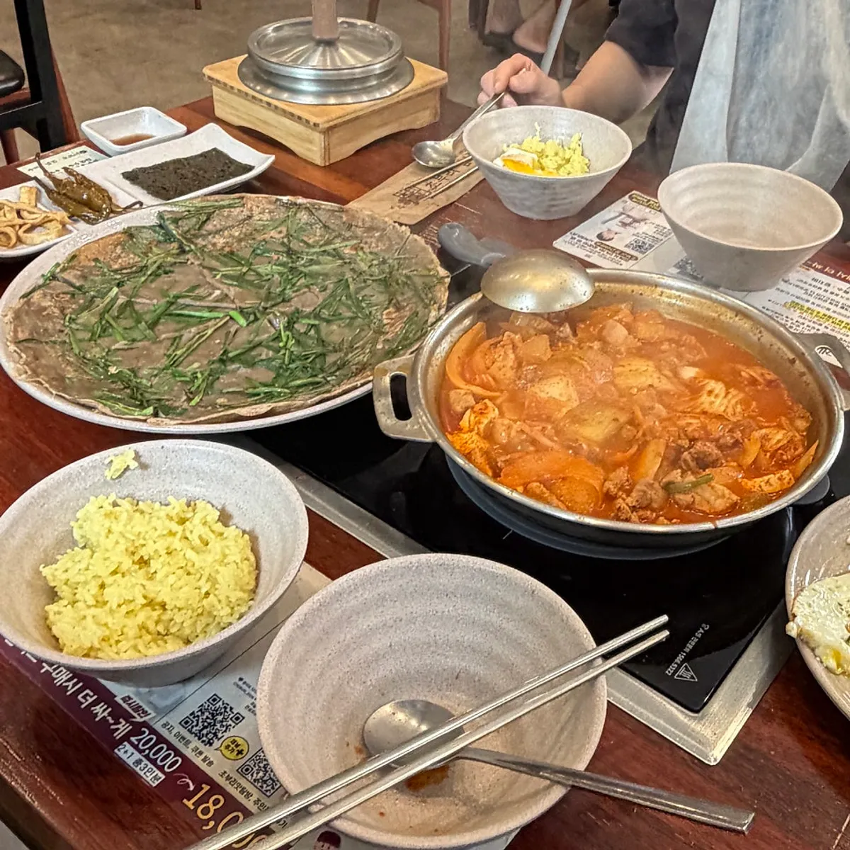 Full spread with kimchi jjigae and scallion buckwheat pancake