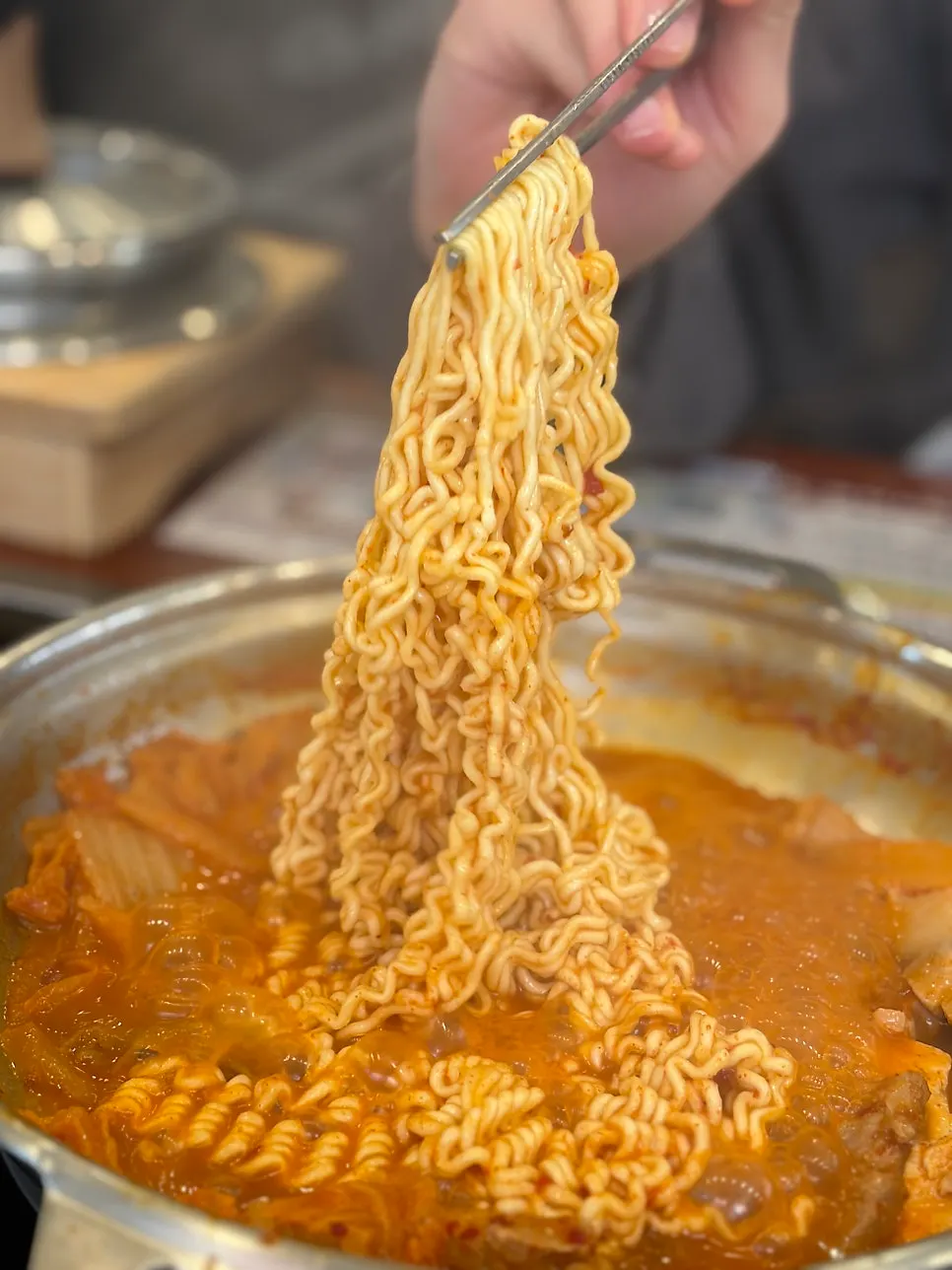 A bite of ramyeon cooked in kimchi jjigae broth