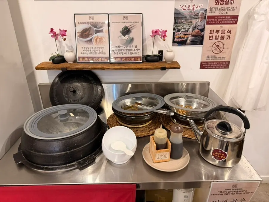 Self-serve bar with kimchi jjigae broth and rice