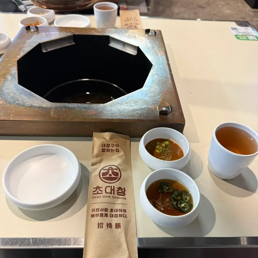 Table setting with a variety of side dishes at Chodaechang Baekseok Branch