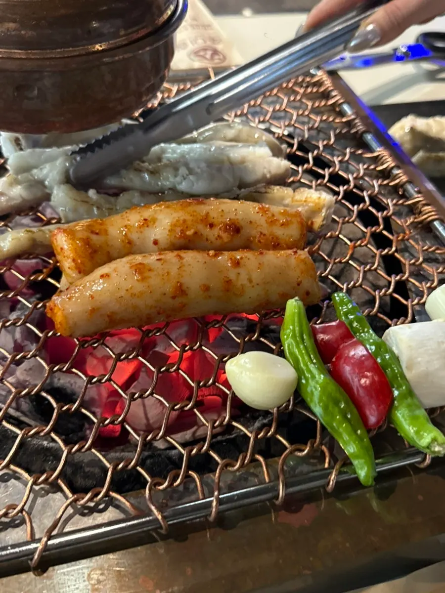 Gopchang and daechang placed on the grill at Chodaechang