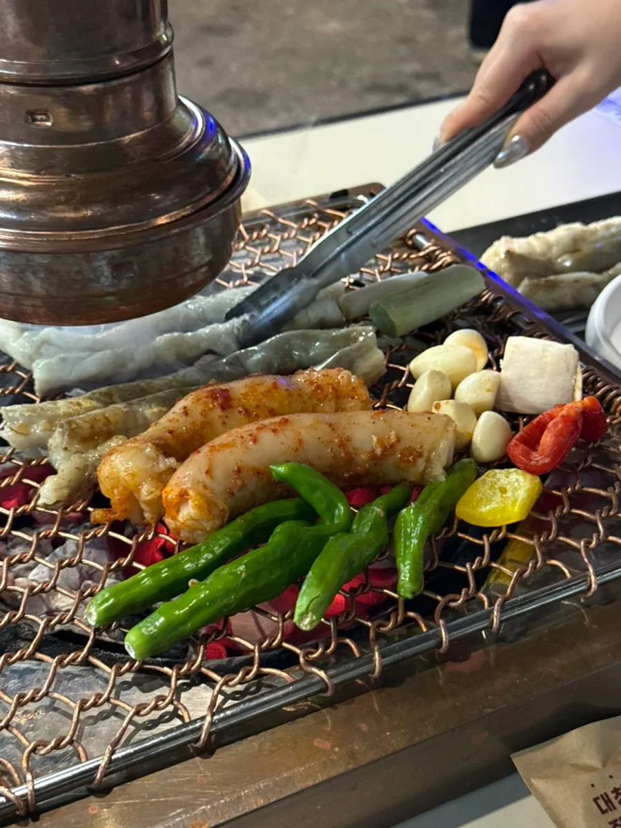 Gopchang cooking on the tabletop grill