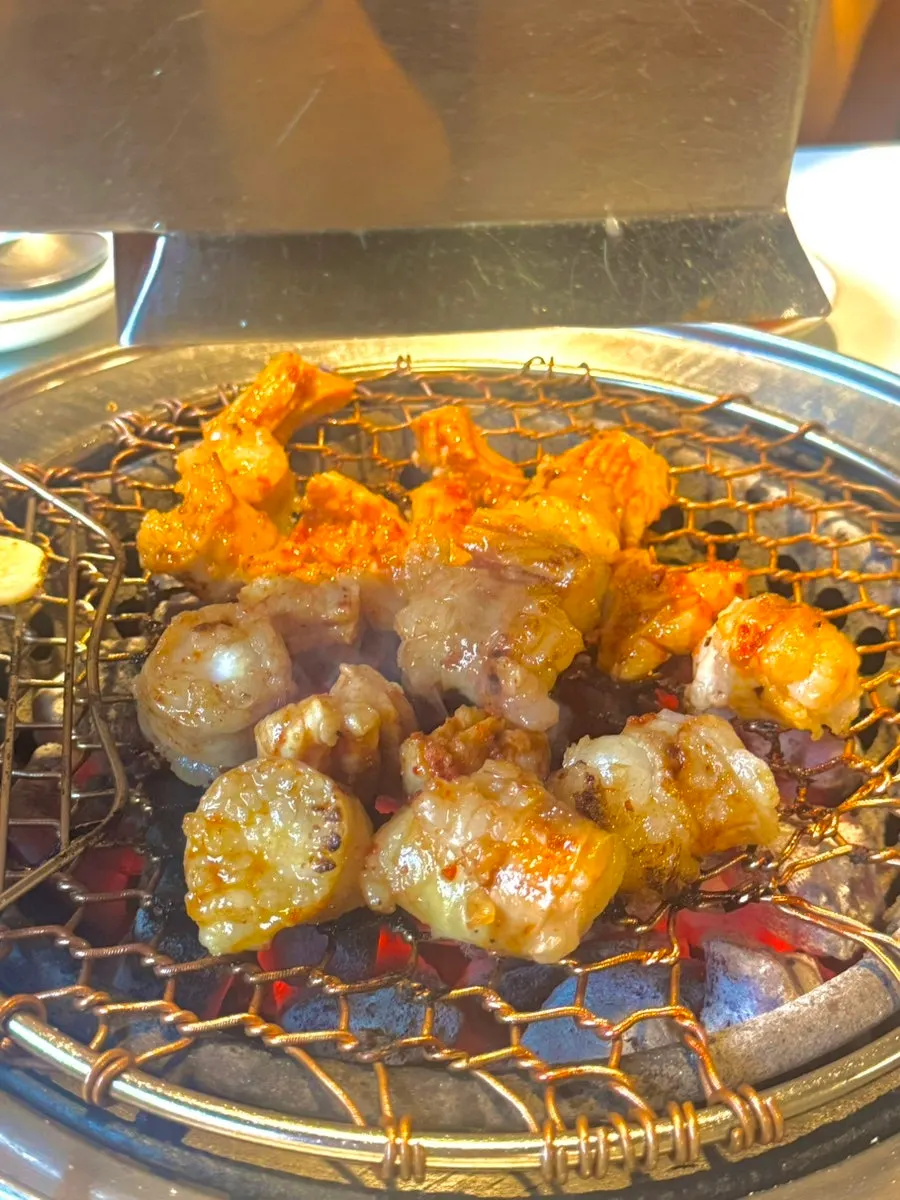 Daechang and teuk-yang grilling together on the charcoal grill