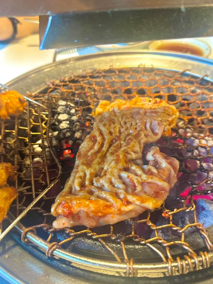 Whole makchang placed on the charcoal grill