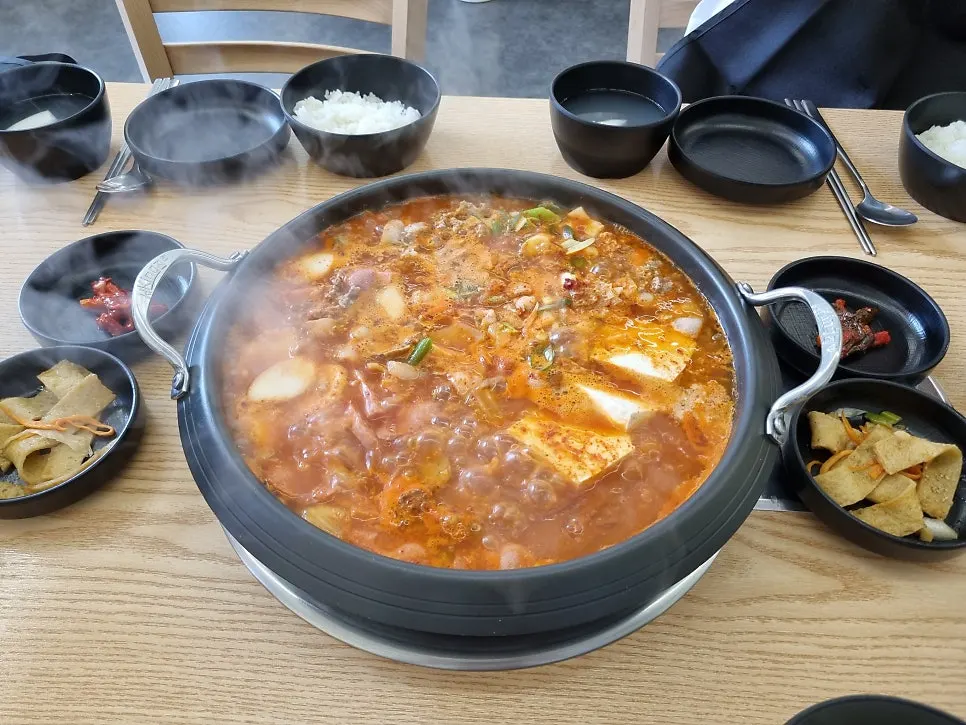 A pot of budae-jjigae piled high with ham and sausage