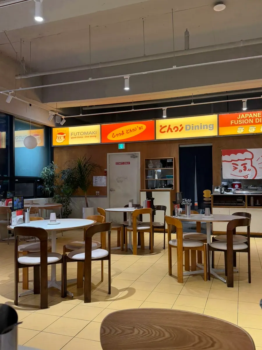 Yellow and wood-toned interior of Choi Dining