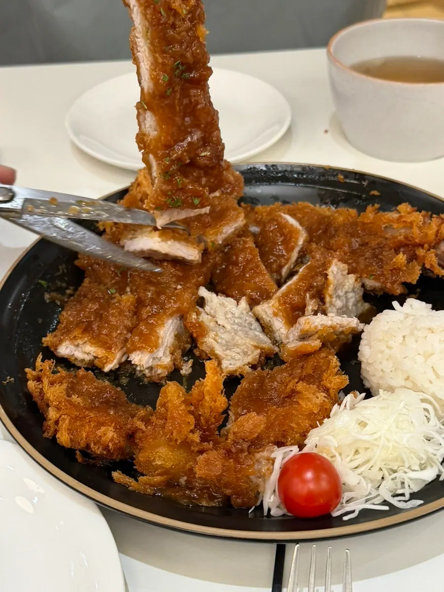 Cross-section of bone-in tonkatsu cut with a knife