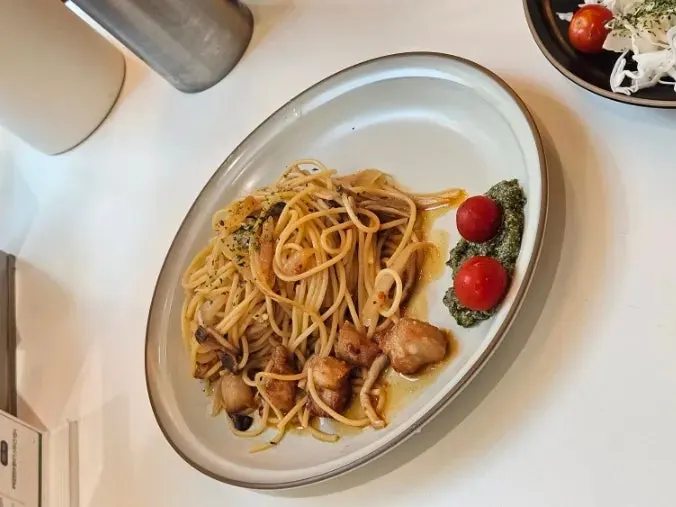 Pork jowl wild garlic oil pasta lifted with a fork