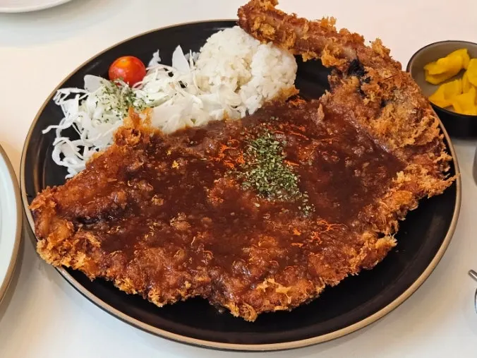 Cross-section of the bone-in tonkatsu cut into bite-sized pieces