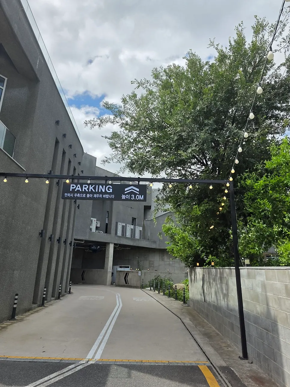 Parking lot sign next to the Choi Main Branch building