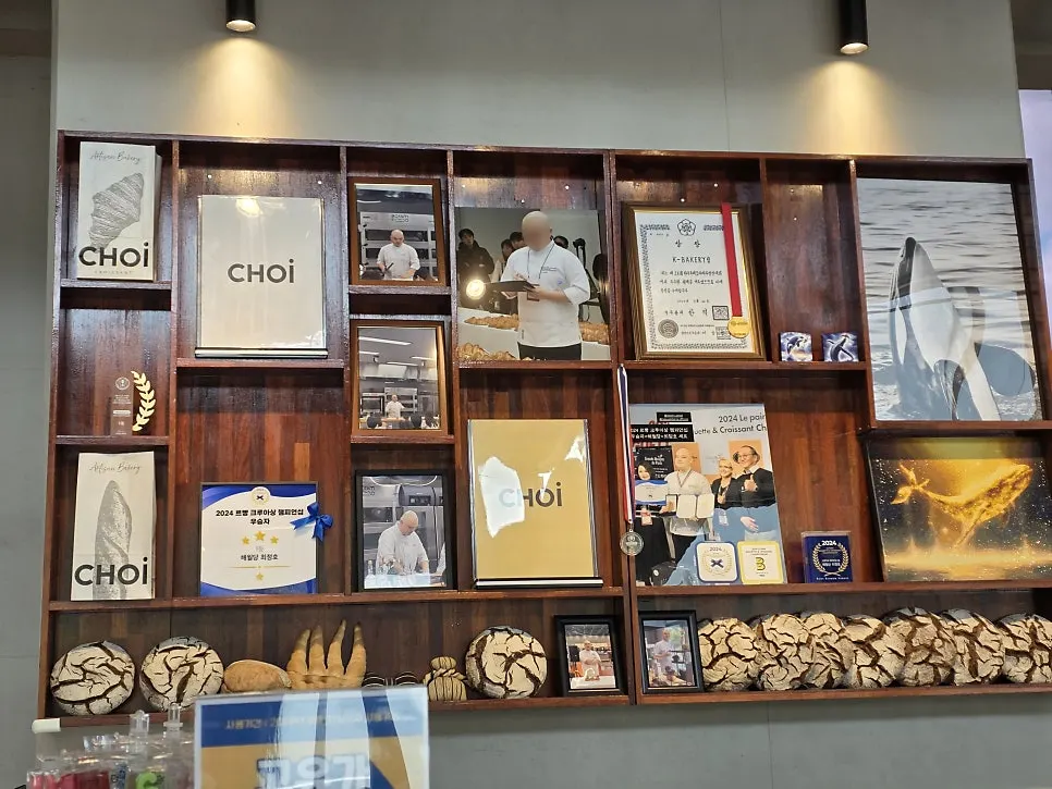 Chef photos, certificates, and medals displayed inside the store