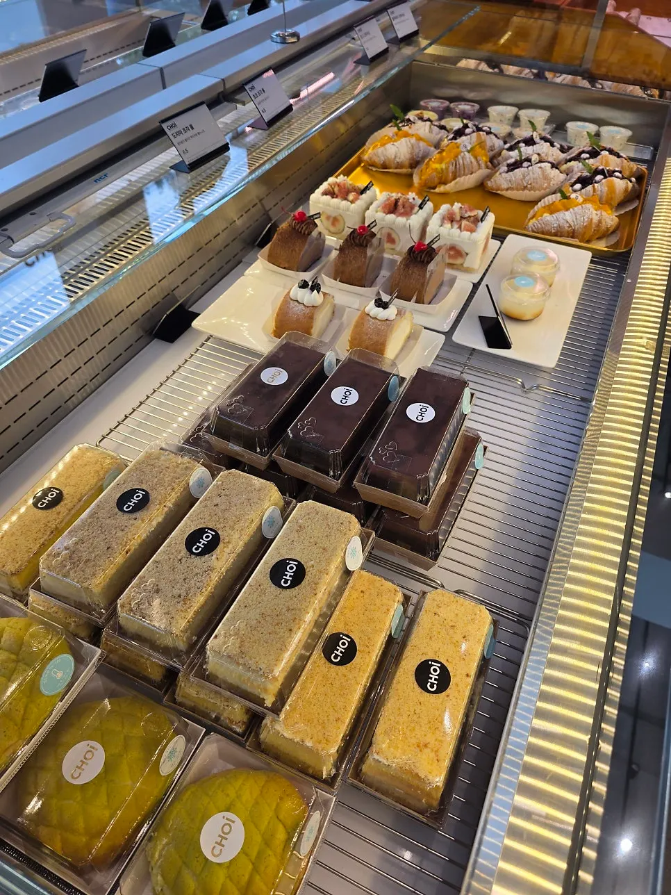 Vertical photo of various breads on the display shelf