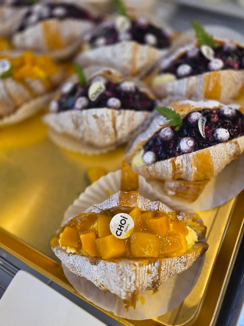 Croissants with visible layered folds on display