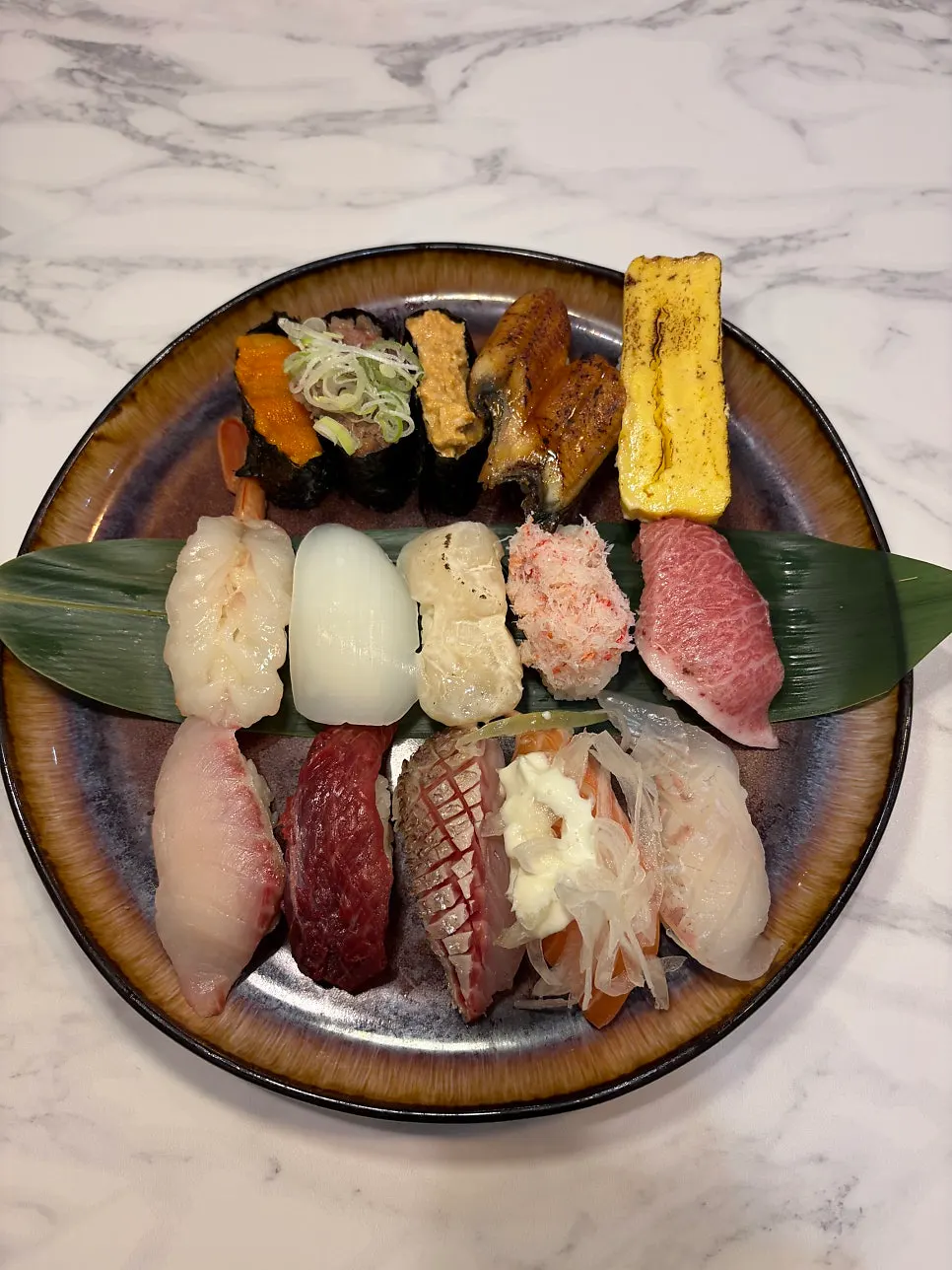 Mixed sushi featuring thick egg sushi