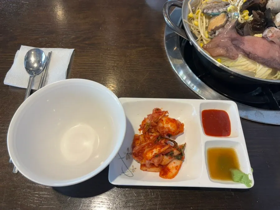 Basic side dishes of kimchi, chojang, and wasabi soy sauce