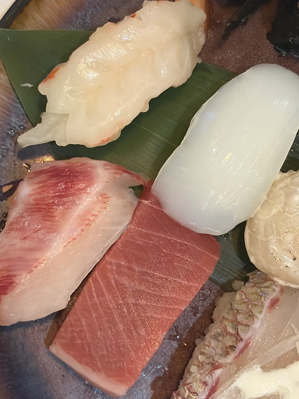 White fish sushi with visible grain in the flesh