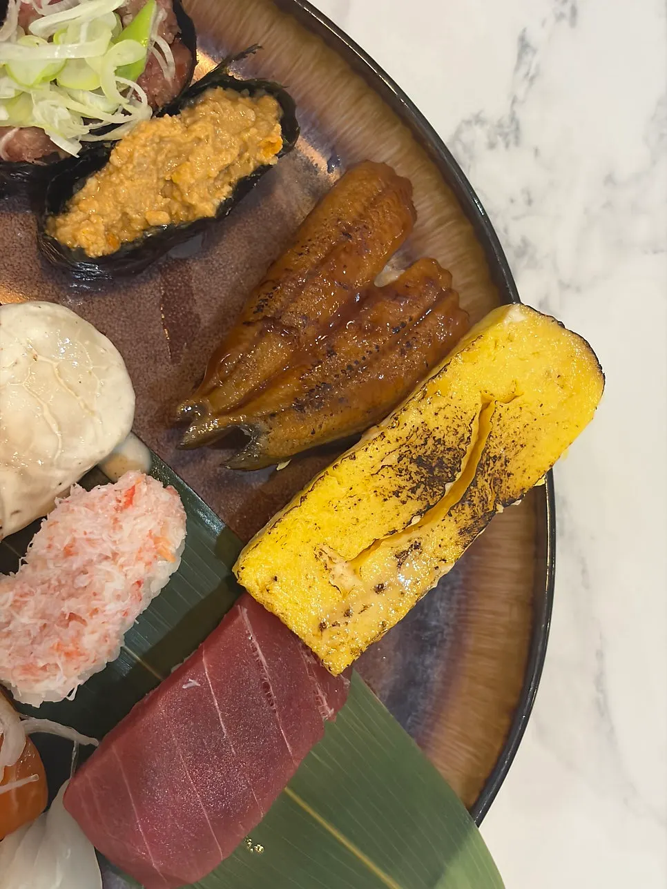 Sauce-glazed eel sushi and torch-seared egg sushi