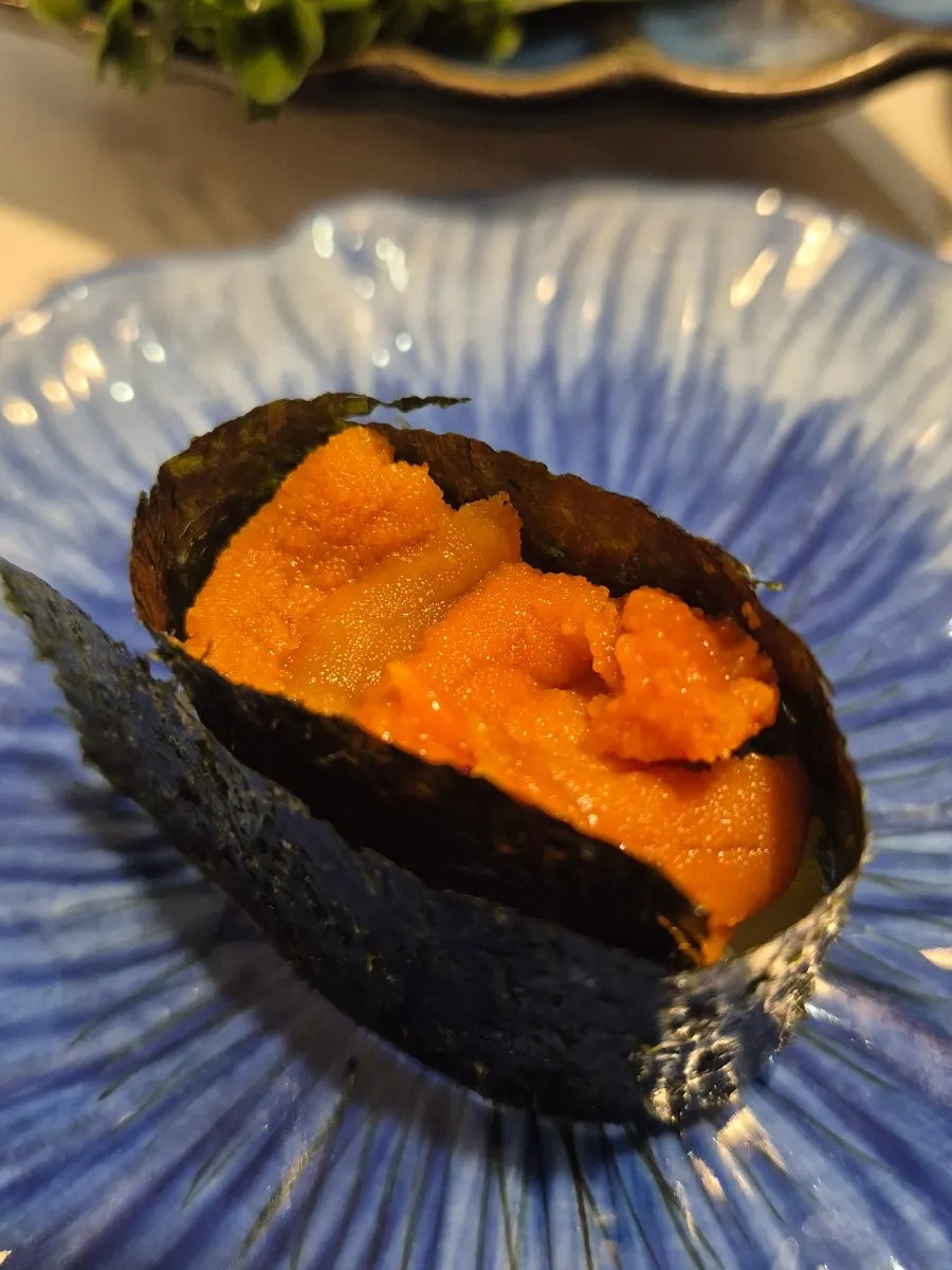 A piece of sushi dipped in soy sauce
