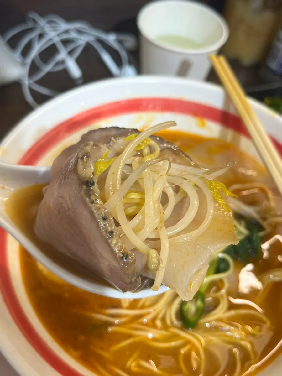 Ramen noodles lifted with chopsticks
