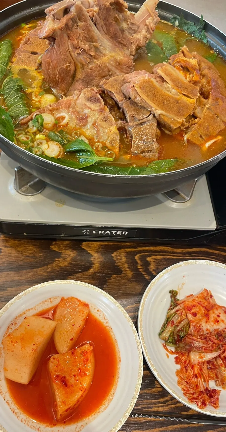 Gamjatang ingredients scooped up along with perilla leaves