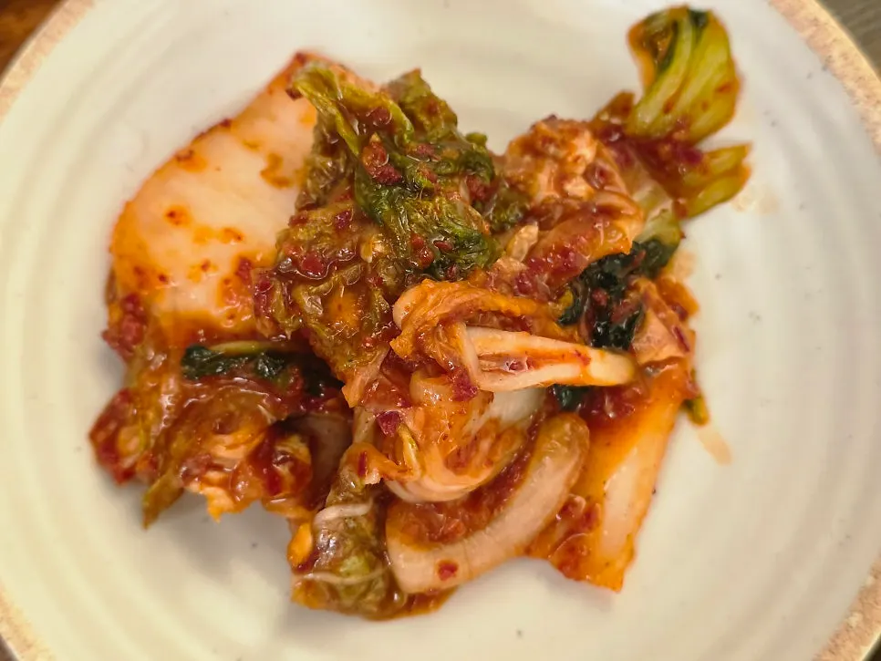 Two kinds of basic kimchi served in ceramic bowls