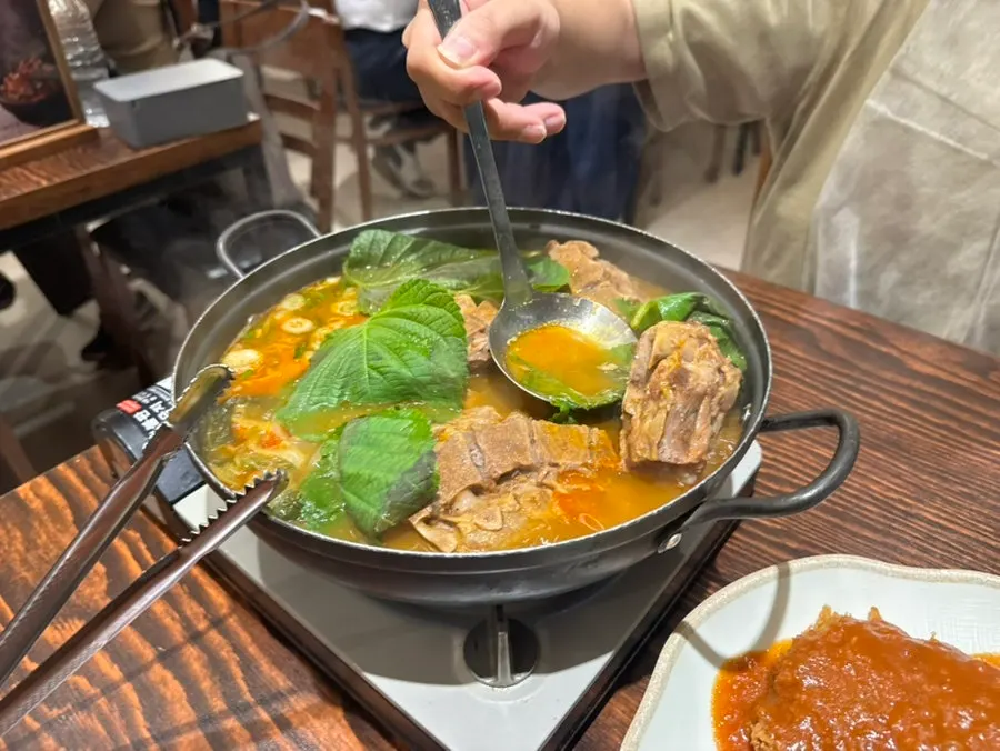 Ladling broth over the gamjatang