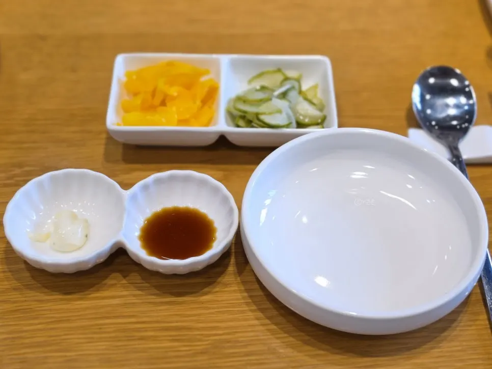 Basic side dishes of pickled radish and house-made cucumber pickles