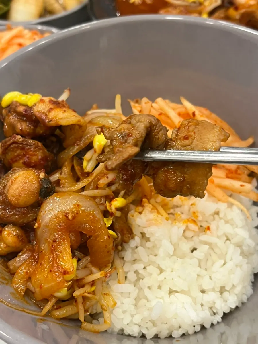 Octopus stir-fry mixed with seasoned greens on top