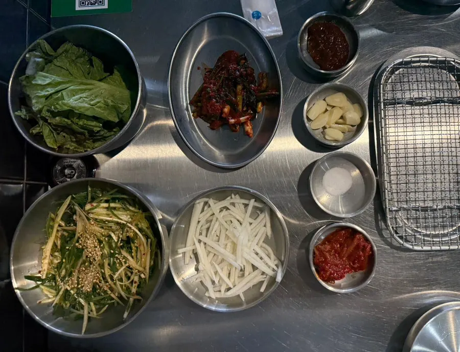 Basic table setting including scallion salad and scallop jeotgal