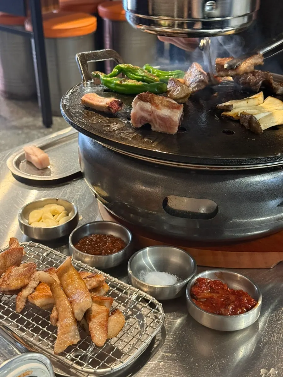Fresh ribs grilling on a cast-iron plate