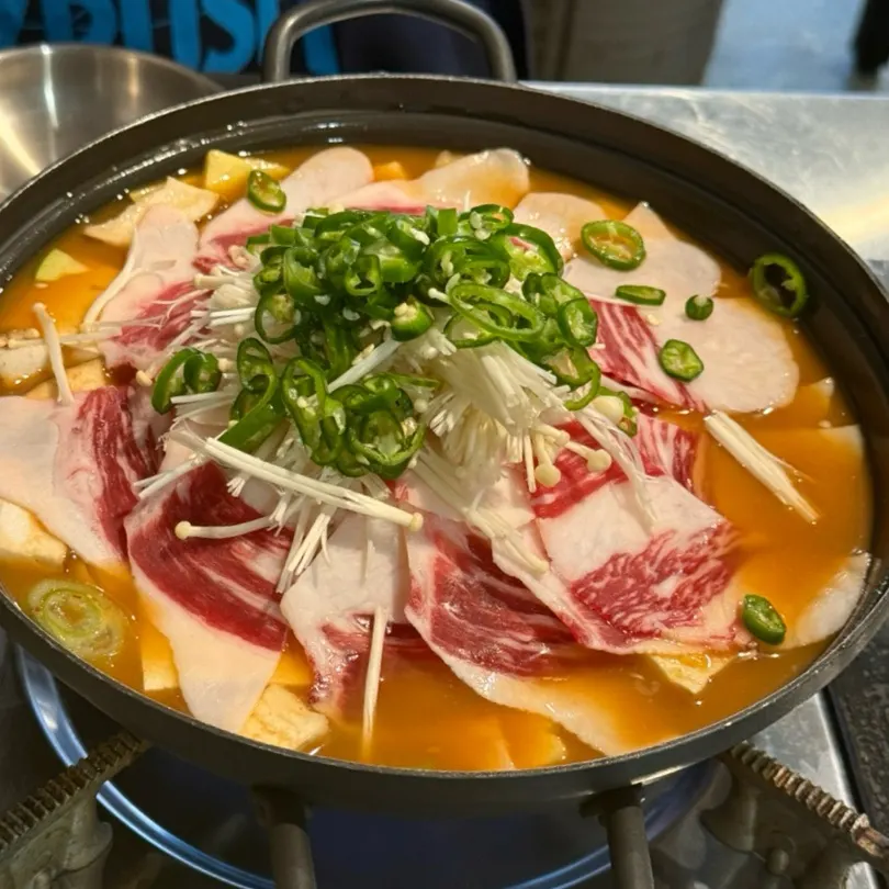 Pot of Hanwoo beef brisket doenjang rice covered with brisket
