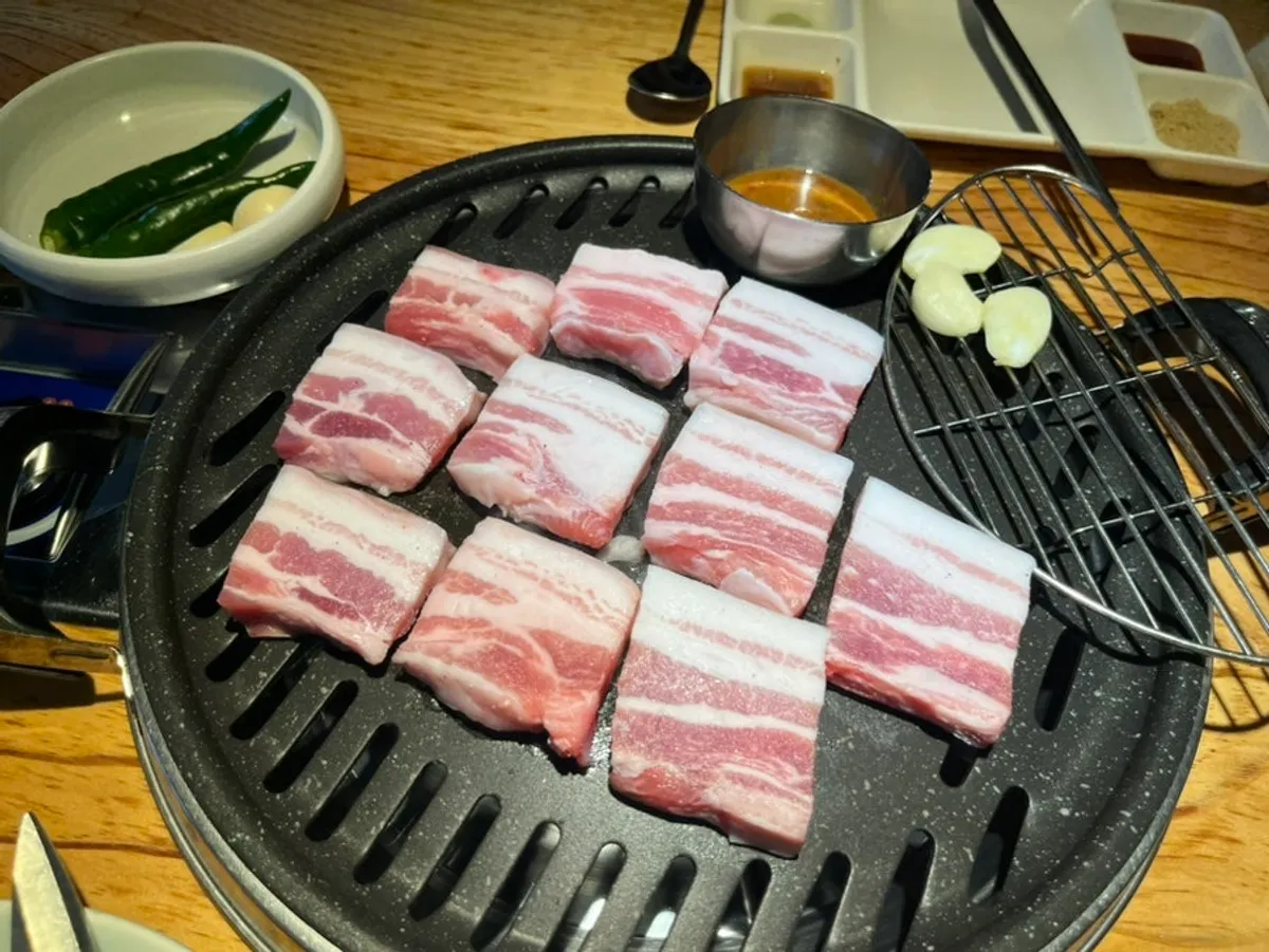 Table spread of ogyeopsal at Chopilsal Pork Grill Hongdae Branch