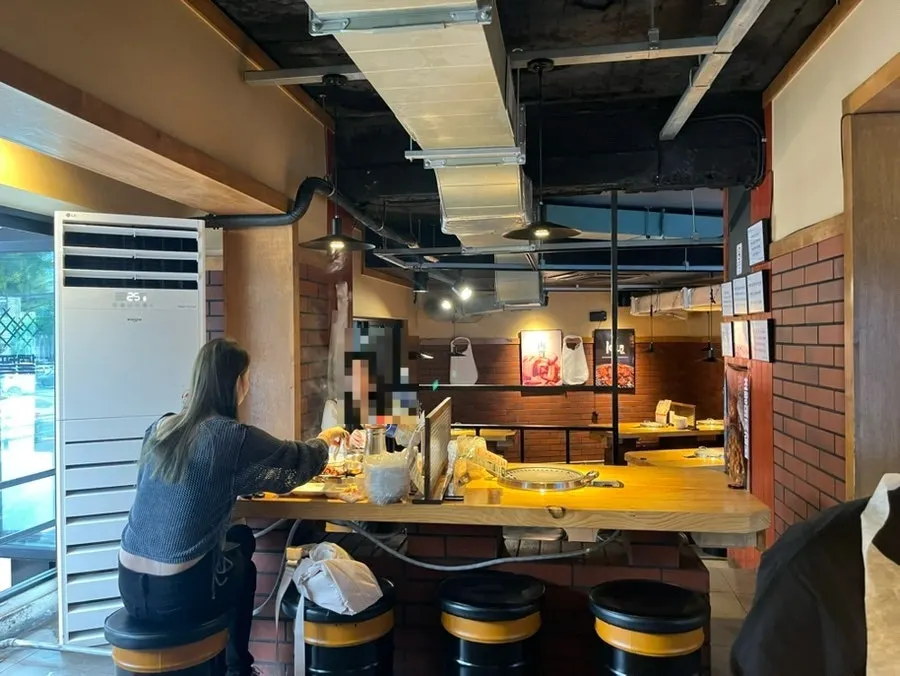 Interior with generous table spacing at the Hongdae meat restaurant