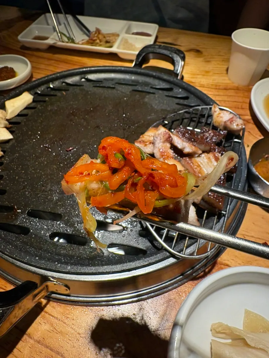 Ogyeopsal grilling to a golden brown on the grill