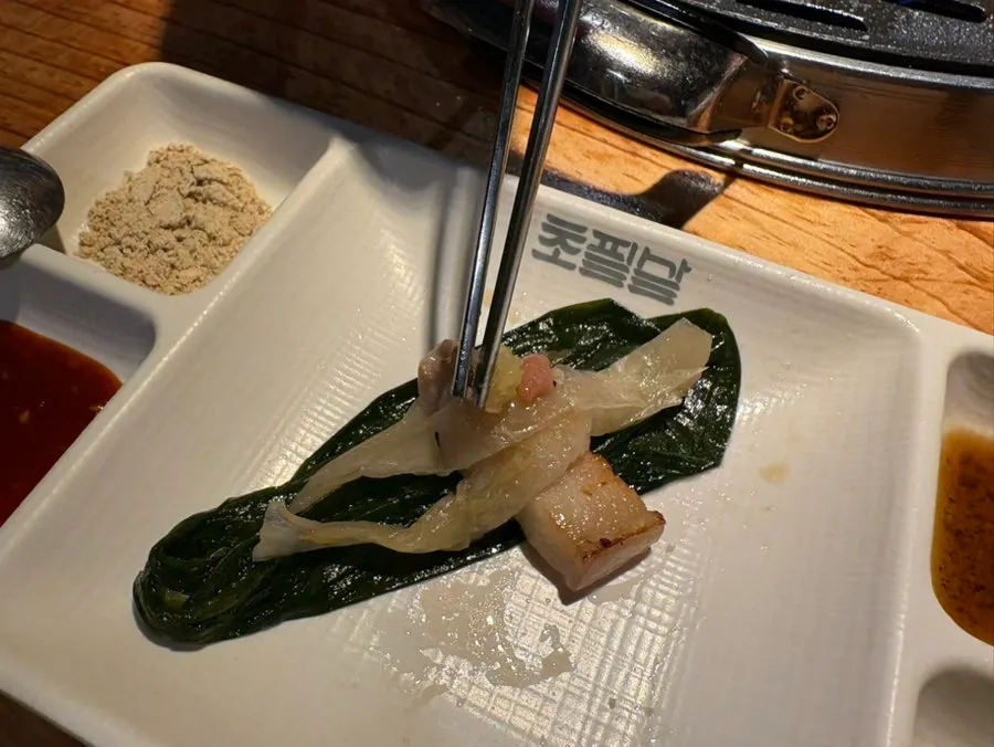 Ogyeopsal wrap topped with wild garlic and mentaiko
