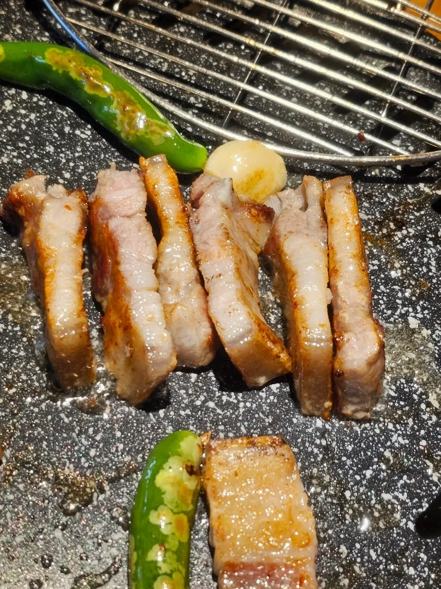 A piece of pork belly with vegetables