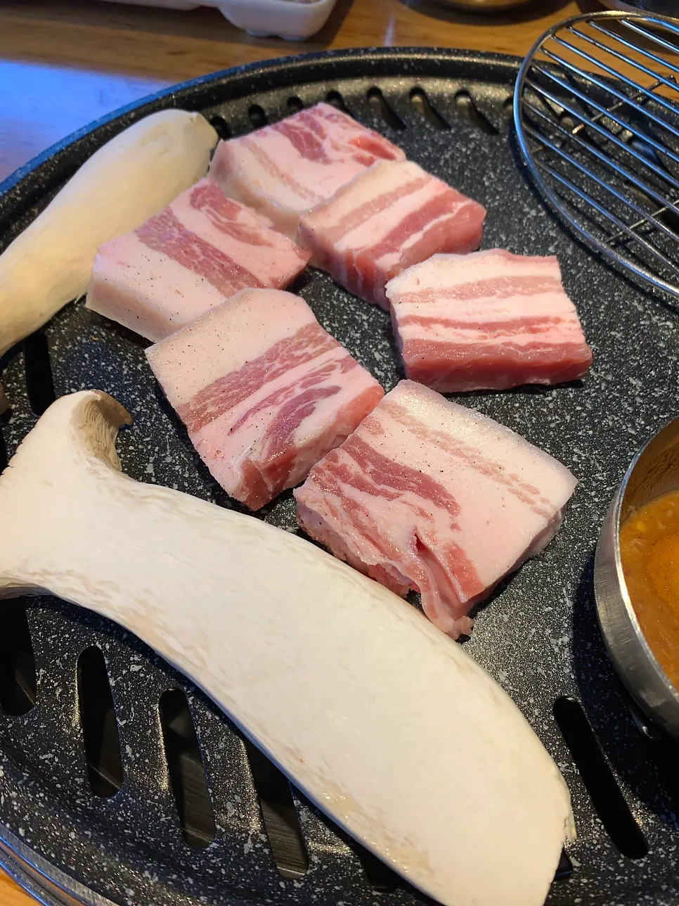 Raw salted pork belly sprinkled with salt and pepper