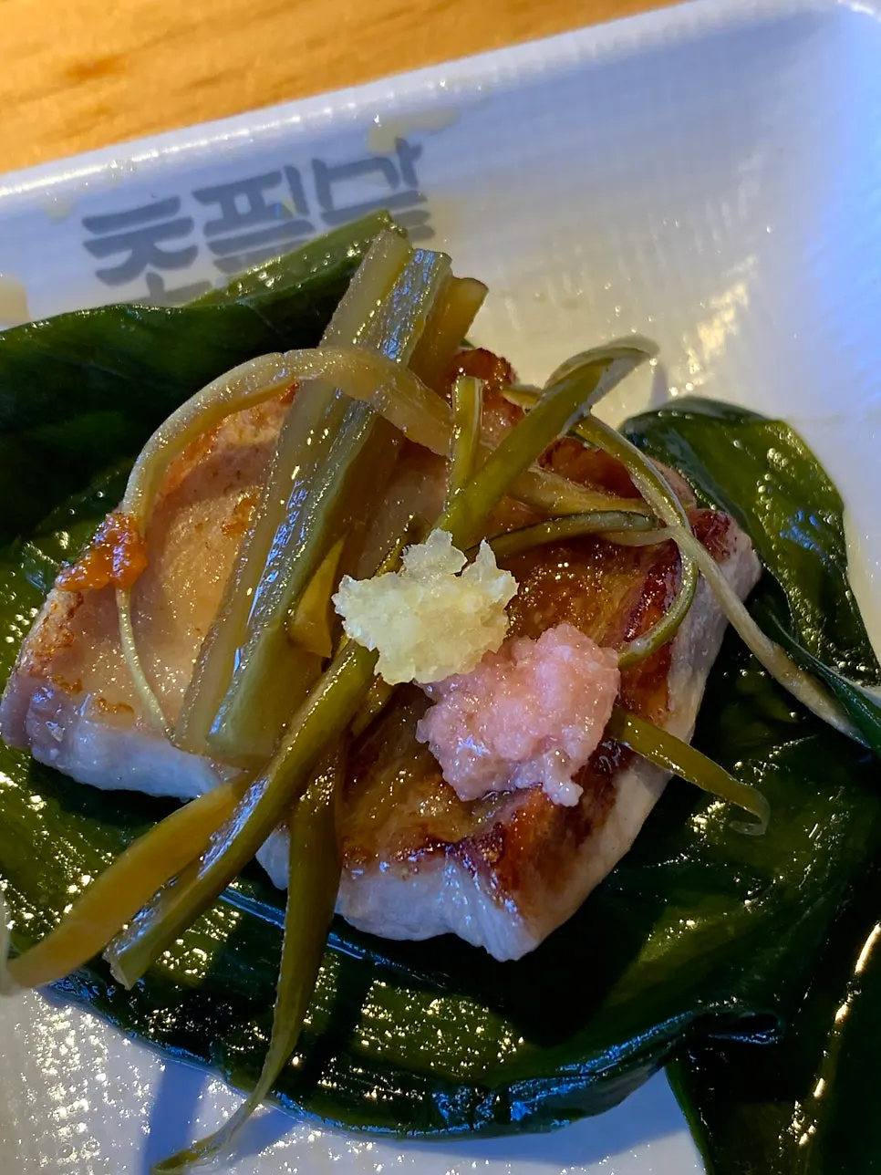 A grilled piece of pork belly enjoyed with sauce