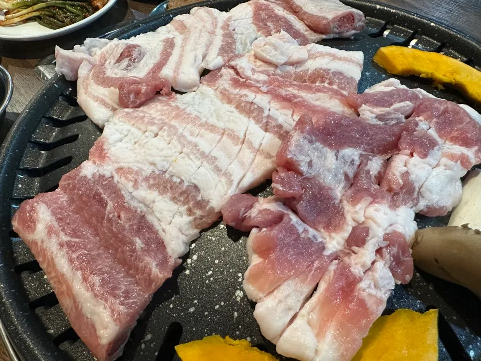 Raw pork ribs grilling on the tabletop grill