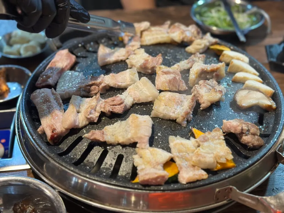 Staff member grilling the raw ribs