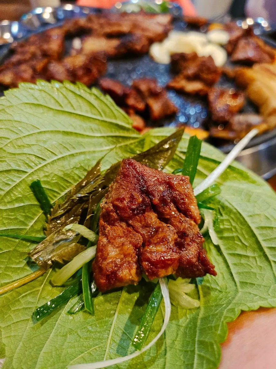 Marinated galbi placed on top of white rice