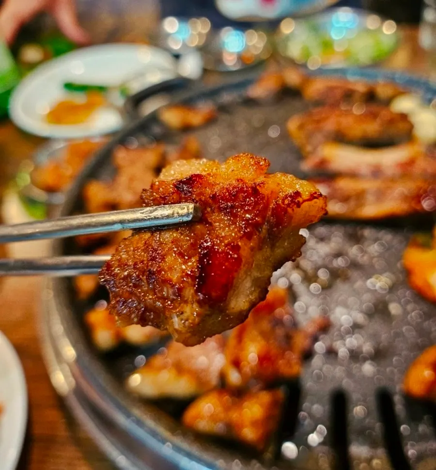 A full spread of marinated galbi and side dishes at Choryang Hyeongje Galbi