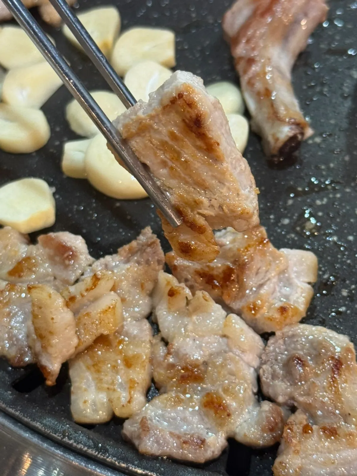 Fresh pork ribs grilling on the grill pan
