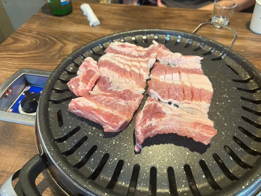 Raw pork ribs from Choryang Hyeongje Galbi on the grill