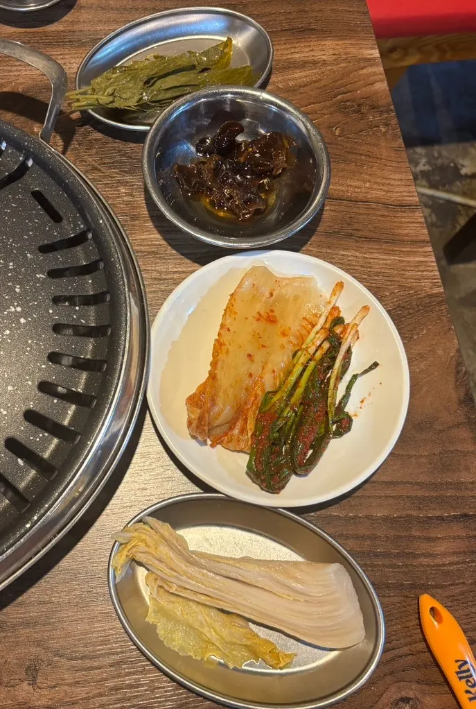 Table spread of basic side dishes with kimchi and scallion kimchi
