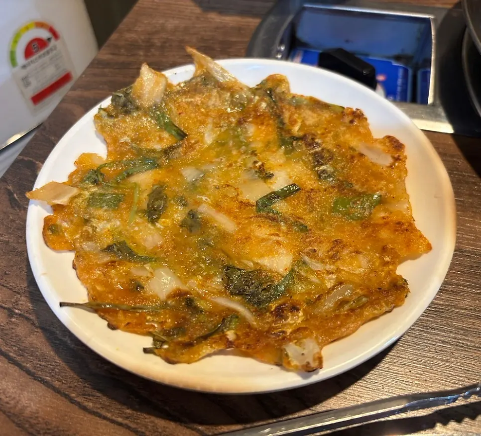 Free kimchi pancake and steamed egg served at the table